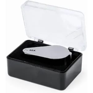 A sleek silver magnifier housed in a clear case with a black base, designed for portable use.