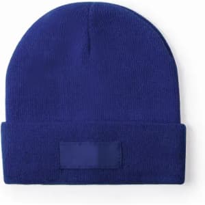 A blue beanie with a folded cuff, featuring a blank label on the front.