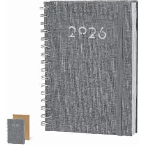 A grey spiral-bound notebook with the year '2026' printed on the cover, alongside a smaller notebook.
