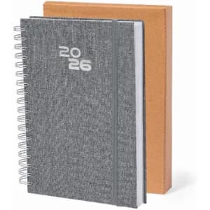 A grey spiral-bound notebook with the year '2026' prominently displayed, alongside a brown hardcover notebook.