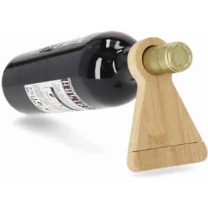 A drink bottle holder made of wood, holding a dark glass bottle with a gold cap.
