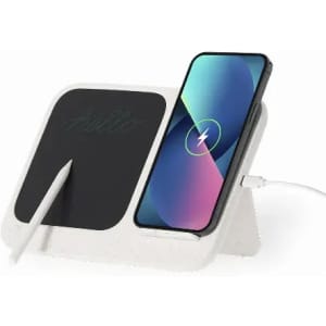 A charging station with a black surface and a smartphone displaying a charging indicator, alongside a stylus.