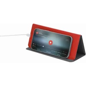 A phone stand with a red and black design, displaying a phone playing video content while charging.