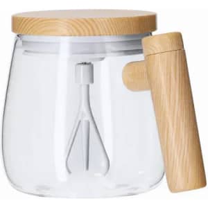 A glass mixing bowl with a wooden lid and a handle featuring a white whisk inside.