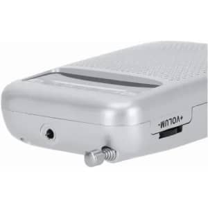 A silver portable radio with a textured surface, featuring a volume control and antenna. It includes a headphone jack.