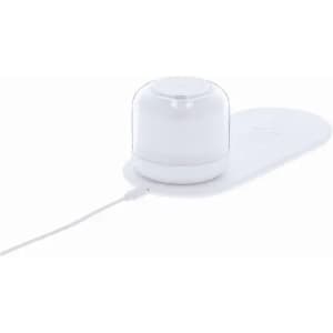 A white diffuser with a translucent lid, resting on a light base, connected by a power cable.