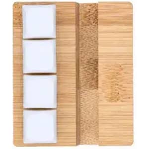 A bamboo serving board with three white ceramic bowls neatly arranged on it.