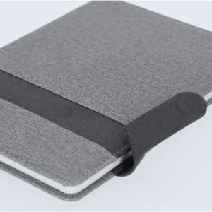 A grey notebook with a fabric cover and an elastic band closure.
