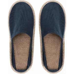 A pair of navy blue slip-on shoes with a jute sole and a woven trim.