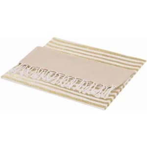 A beach towel with a striped gold and cream design, featuring a fringed edge and a plain section.