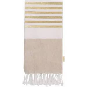 A decorative towel featuring white and beige stripes with gold accents and fringed edges.