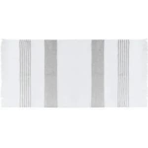 A white bath towel with grey stripes and fringed edges, featuring a simple and elegant design.