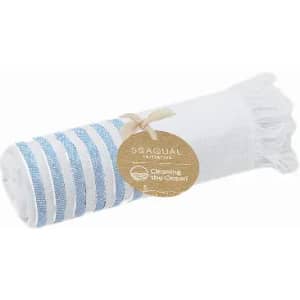 A rolled towel featuring white and blue stripes, with a tag attached. The towel has fringe details at one end.