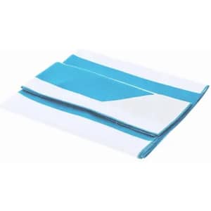A folded towel in white and teal, featuring a geometric design with alternating stripes. It has a logo.