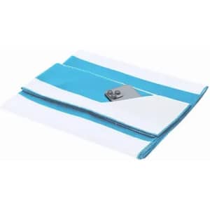 A beach towel featuring a white and turquoise design, with a small pocket and a button closure.
