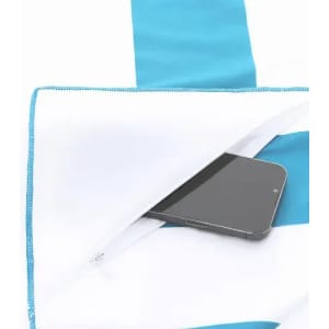 A towel with blue and white stripes, featuring a hidden pocket containing a smartphone.