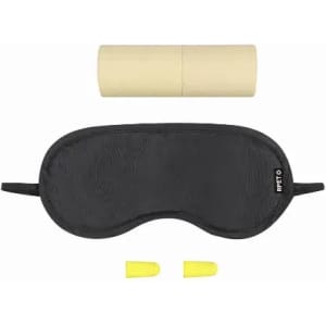 A sleep mask in black with yellow earplugs and a cylindrical storage case in beige. Features a logo.