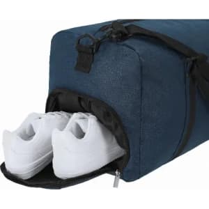 A gym bag in navy blue with a zippered compartment containing white sneakers. Features a shoulder strap and handle.
