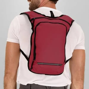 A red backpack with black accents, worn by a person from behind, featuring adjustable straps and a sleek design.