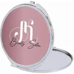 A compact mirror with a pink exterior and a silver frame, featuring a logo and the text "Beauty Salon" inside.