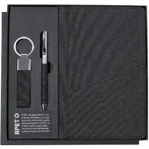 A black gift set featuring a notebook, pen, and keyring, all presented in a matching black box with a branding logo.