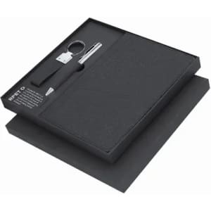A gift set featuring a black notebook, pen, keyring, and presented in a sleek black box.