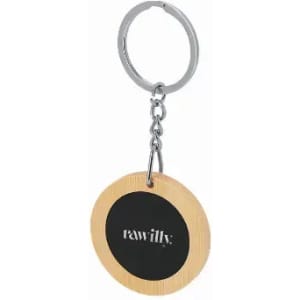 A keychain featuring a circular wooden tag with a black centre and a metallic ring attached.