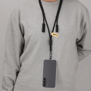 A phone holder with a lanyard, featuring a sleek black design, attached to a grey sweater.