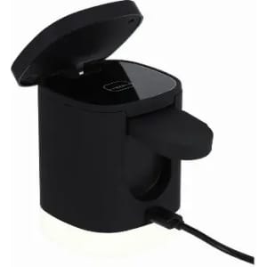 A black electric mug warmer with a lid and a white base. It has a power cord attached.