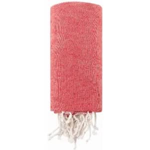 A rolled-up red towel with white fringes at one end, featuring a textured pattern.