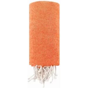 An orange towel with white fringes, neatly rolled up. The fabric appears textured and soft.