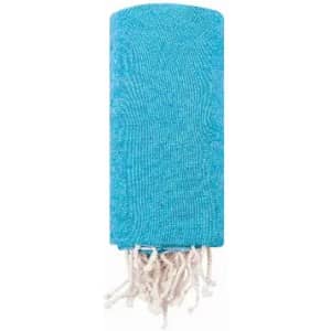 A blue towel with decorative fringes at one end, neatly folded. The fabric appears textured.