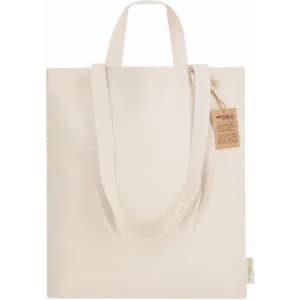 A tote bag in a natural beige colour with two handles and a small tag. It features a simple, unadorned design.