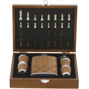 A wooden gift set including a flask and two shot glasses, with a fitted chess piece design inside the lid.