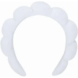 A white headband featuring a scalloped design. It has a soft texture and a simple, elegant appearance.