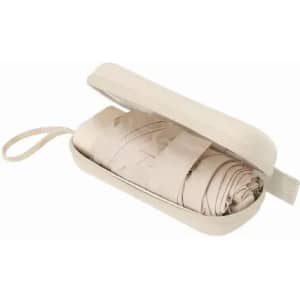 A travel blanket neatly rolled and stored in a cream-coloured case with a zipper and a carrying strap.