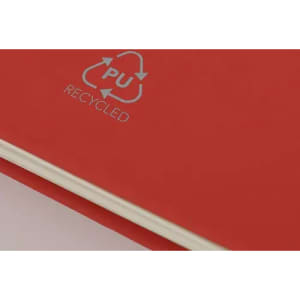 A red notebook featuring a recycled material symbol, with a smooth cover and cream-coloured pages.