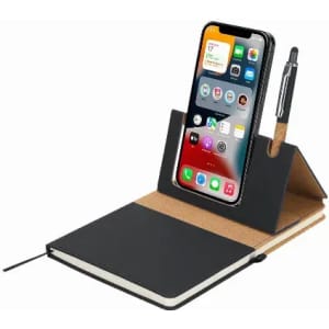 A notebook with a dark cover, featuring a phone holder and a pen. The phone is displaying various apps.