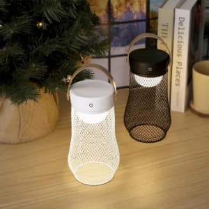 A battery-operated lantern in black and white mesh designs, featuring a handle and a warm light bulb.