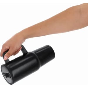 A drink bottle in black with a handle, held by a hand, featuring a spout and a logo.