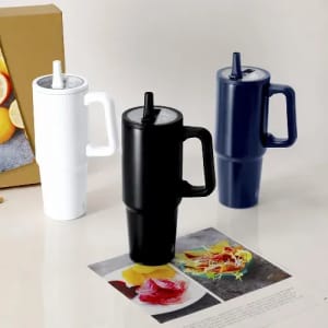 A drink bottle set featuring three colour options: white, black, and navy, with a handle and straw.