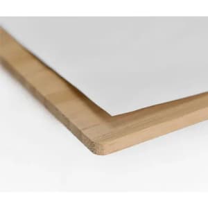 A wooden picture frame corner with a white backing paper, featuring a natural wood finish.