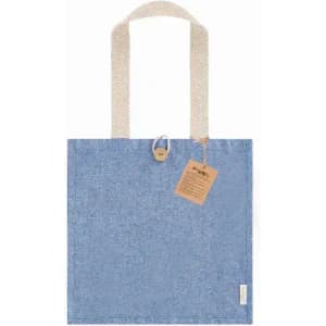 A blue tote bag with light-coloured handles and a tag attached, featuring a textured fabric design.