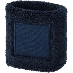 A dark navy wristband made of soft terry cloth, featuring a square patch. It has a simple, textured design.