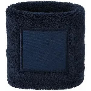 A dark blue wristband made of plush, fuzzy material, featuring a blank square patch.