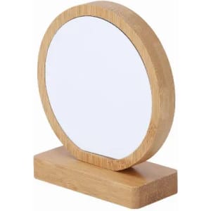 A round mirror with a wooden bamboo frame, featuring a stable rectangular base.
