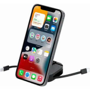 A smartphone on a charging stand with a cable attached, featuring a vibrant home screen display.