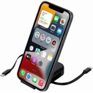 A phone stand with a sleek black design, featuring a charging cable and displaying various app icons on the screen.