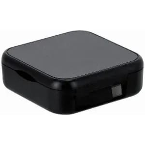 A black square product container with a smooth surface and a small latch on one side. It features a logo.