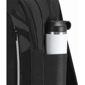 A black backpack with a drink bottle in a side pocket. The bottle is white with a black lid.